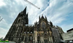 a large building under construction with Cologne Cathedral in the background jigsaw puzzle