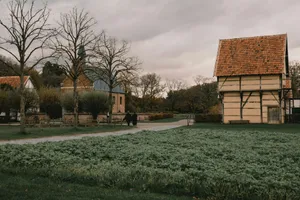 Two people walking past historic half-timbered buildings jigsaw puzzle
