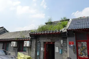 Traditional buildings with grass-covered roofs under a cloudy sky. jigsaw puzzle