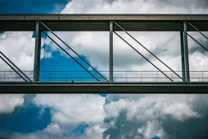 Modern metallic bridge against a blue sky with white clouds. jigsaw puzzle