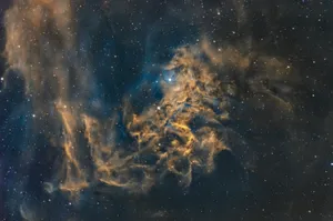 A nebula with swirling golden clouds and stars. jigsaw puzzle