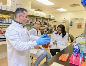 a group of people in a lab looking at something jigsaw puzzle