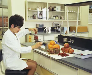 a woman in a white lab coat sitting at a counter in front of a sink jigsaw puzzle