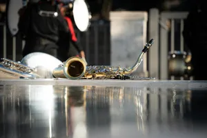 A trumpet laying on the ground in front of a man jigsaw puzzle