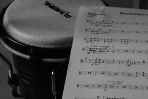 A sheet of music sitting on top of a drum jigsaw puzzle