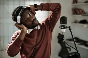 a man wearing headphones while standing in front of a microphone jigsaw puzzle