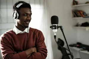 a man wearing headphones standing in front of a microphone jigsaw puzzle