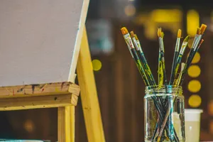 a group of brushes sit in a glass cup jigsaw puzzle