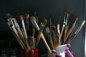 A bunch of paint brushes and a sprayer in a cup jigsaw puzzle