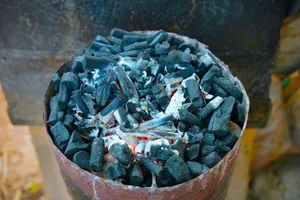 Burning charcoal inside of a metal container. jigsaw puzzle