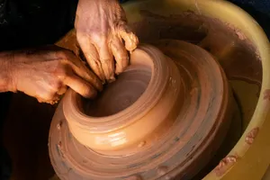 person holding round brown wooden plate jigsaw puzzle