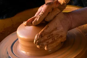 person making clay pot with clay jigsaw puzzle