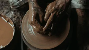 a potter's hands on a potter's wheel making clay jigsaw puzzle