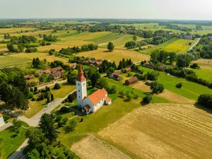 Aerial shot of a rural church surrounded by fields in Velika Trnovitica, Croatia. jigsaw puzzle
