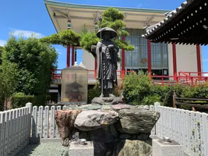 Peaceful Buddha statue in a traditional Japanese temple garden on a sunny day. jigsaw puzzle