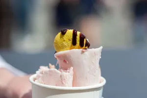 Close-up of rolled ice cream topped with a chocolate-drizzled macaron. Perfect dessert treat. jigsaw puzzle