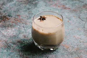 From above of tasty sweet cocktail with milk and spice served on table jigsaw puzzle
