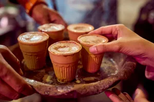 Close-up of masala chai served in clay cups by a street vendor, capturing authentic Indian culture. jigsaw puzzle