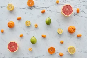 Colorful citrus fruits arranged on a marble surface showcasing freshness and variety. jigsaw puzzle