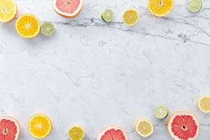 Flat lay of assorted citrus slices on a marble surface with ample copy space. jigsaw puzzle