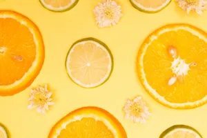 Top-down view of citrus slices with white flowers on a bright yellow background, offering fresh vibes. jigsaw puzzle