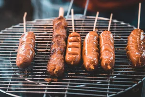 Close-up of delicious sausages cooking on a smoky BBQ grill. Perfect for food photography enthusiasts. jigsaw puzzle