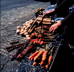 Delicious street food barbecue with skewers and eggs in Hà Giang, Vietnam outdoors. jigsaw puzzle