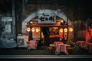 A charming Tokyo izakaya outside view at night with warm lighting and red checkered tables, perfect for urban nightlife scenes. jigsaw puzzle