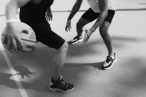 Monochrome image capturing intense basketball action and dribbling on the court. jigsaw puzzle