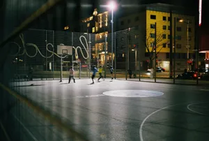 Men playing basketball on an urban court in Vienne at night. jigsaw puzzle