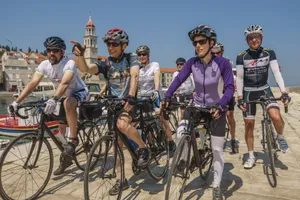 Cyclists gather for a ride along the scenic Adriatic coast in a sunny European town. jigsaw puzzle