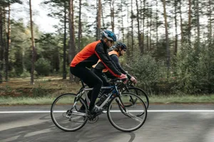 Two cyclists riding through a scenic forest, enjoying a leisure bike ride. jigsaw puzzle