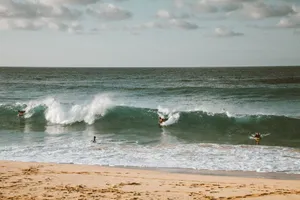 Surfers ride the waves on a sunny day at the beach. Perfect for vacation vibes. jigsaw puzzle