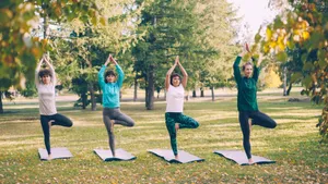 Four women performing yoga in a tranquil park during a sunny fall day. jigsaw puzzle