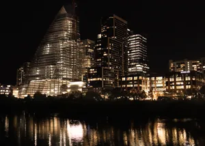 Illuminated skyscrapers reflecting in the river at night in downtown Austin, Texas. jigsaw puzzle