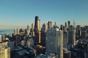 Aerial shot of Chicago skyline featuring high-rise buildings under a clear blue sky. jigsaw puzzle