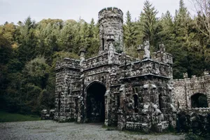 Explore the historic Gothic architecture of Ballysaggartmore Towers nestled in an Irish forest. jigsaw puzzle