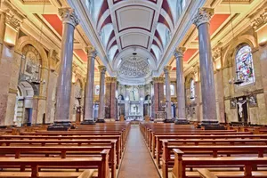 Bright view of a historic church interior in Preston, England, showcasing grand pillars and stained glass windows. jigsaw puzzle