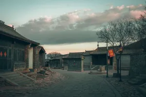 Empty cobblestone street in a historic Chinese village at dusk with traditional architecture. jigsaw puzzle