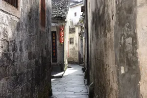 Explore an ancient alley in a traditional Chinese village, showcasing rustic architecture and lanterns. jigsaw puzzle