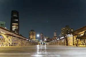 Captivating night view from a bridge showcasing the city skyline and modern skyscrapers. jigsaw puzzle