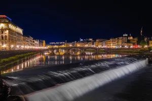 Beautiful nighttime scenery of Florence's Arno River with illuminated buildings and bridge reflections. jigsaw puzzle
