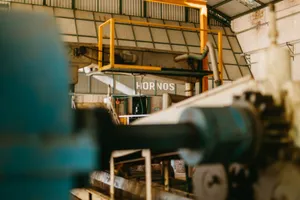 Close-up of heavy machinery inside an industrial factory with focus on ironworks and conveyor systems. jigsaw puzzle