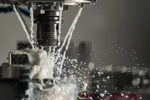 Dynamic close-up of CNC machine with coolant splashing during metalwork operation. jigsaw puzzle