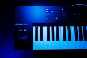 A close-up view of a synthesizer keyboard under blue lighting, perfect for music production or electronic media. jigsaw puzzle