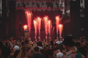 Lively music concert with a crowd and stunning fireworks lighting up the stage. jigsaw puzzle