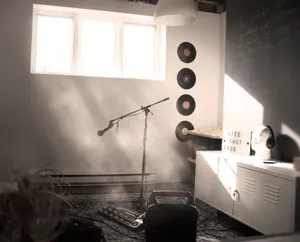 A serene music studio featuring a microphone stand and vinyl records on the wall. jigsaw puzzle