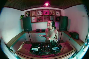 Woman DJ mixes tracks in a cozy studio in Brazil, surrounded by music equipment. jigsaw puzzle