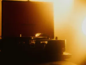 Retro turntable playing vinyl in atmospheric warm lighting, evoking nostalgia. jigsaw puzzle
