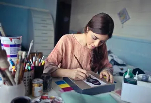 Female artist deeply engaged in painting at her creative studio workspace. jigsaw puzzle